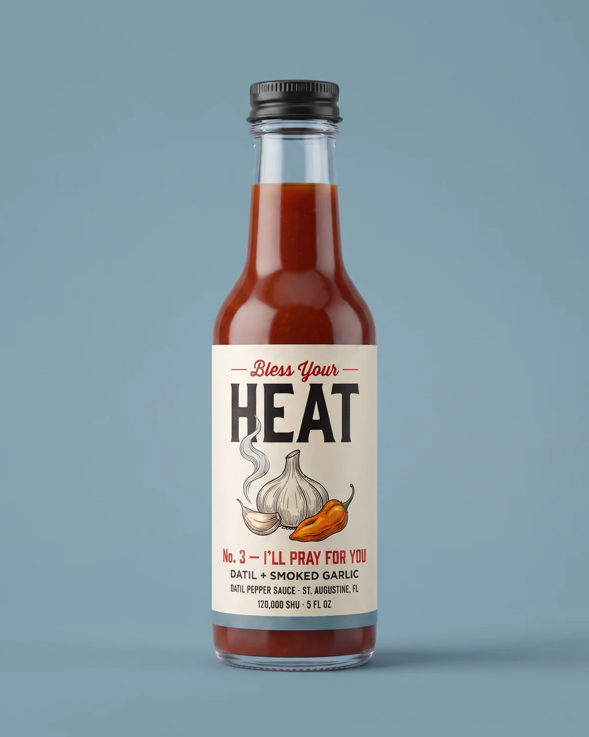 I’ll Pray For You bottle — smoky red-amber garlic sauce on a smoke-blue field.